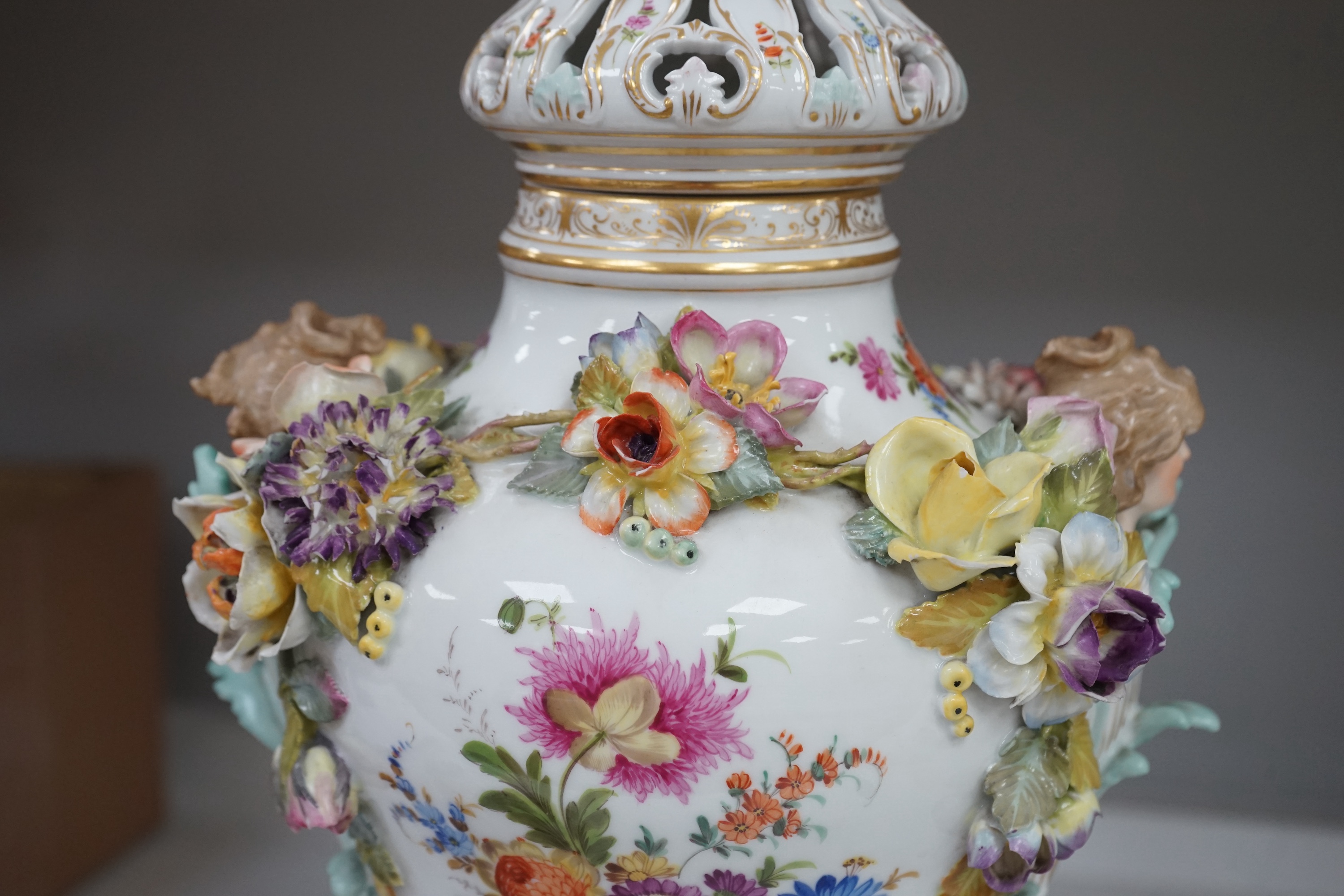 A Dresden floral encrusted porcelain incense burner hand painted with figures annd flowers, together with a similar lidded box, largest 52cm high. Condition - some losses